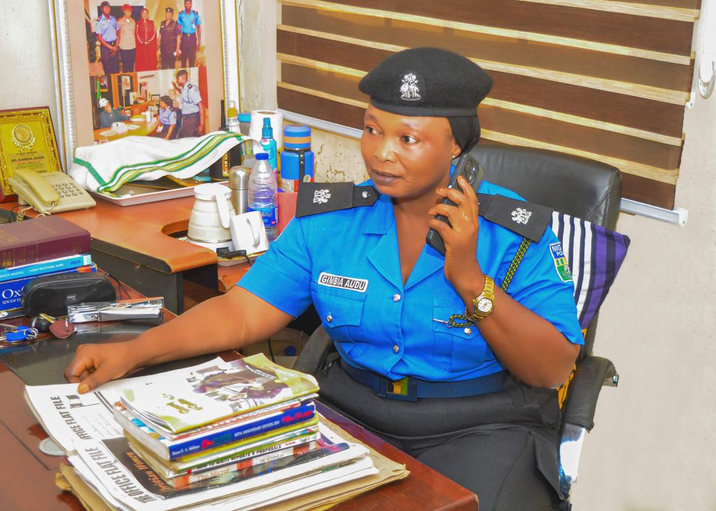 Superintendent Gimbia Audu speaking on the phone at her office