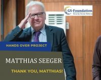 Former GS-Foundation project lead Matthias Seeger smiling and saluting while standing indoors.