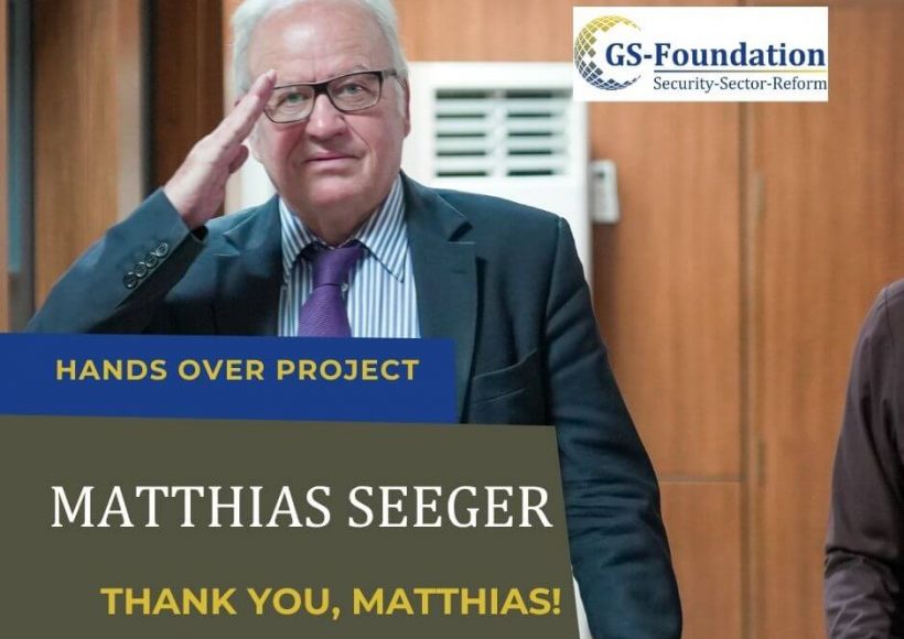 Former GS-Foundation project lead Matthias Seeger smiling and saluting while standing indoors.