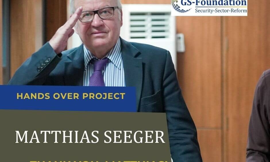 Former GS-Foundation project lead Matthias Seeger smiling and saluting while standing indoors.