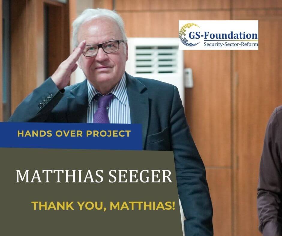 Former GS-Foundation project lead Matthias Seeger smiling and saluting while standing indoors.